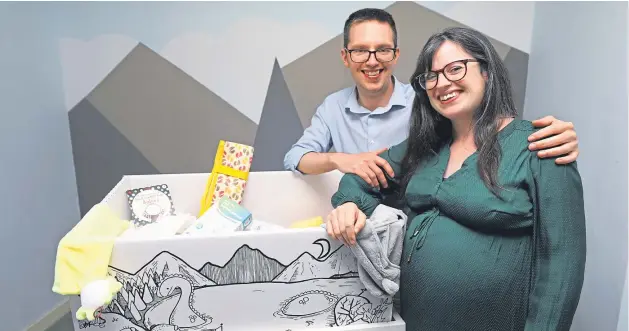  ?? Picture: Dougie Nicolson. ?? Gary Phillips and Anna Mcfarlane at home in Dundee last night exploring the contents of the Baby Box.