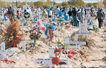  ?? RAYMUNDO RUIZ/AP ?? People visit deceased love ones at a cemetery in Ciudad Juarez, which has borne the brunt of Mexico’s drug war.