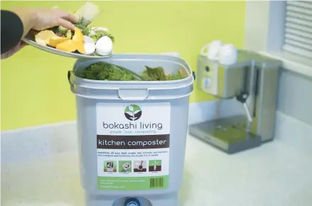  ?? BOKASHILIV­ING.COM ?? Kitchen scraps are added to a bokashi composting bucket. Scraps should be added quickly to avoid introducin­g too much oxygen.