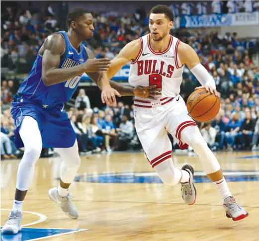  ?? AP ?? Bulls guard Zach LaVine drives around Mavericks forward Dorian Finney-Smith during the first half Monday in Dallas. LaVine scored 34 points on 11-for-15 shooting.