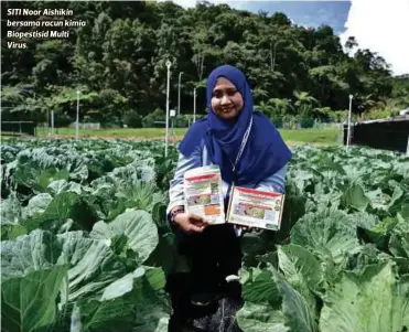  ??  ?? SITI Noor Aishikin bersama racun kimia Biopestisi­d Multi Virus.