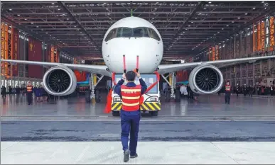  ?? YIN LIQIN / FOR CHINA DAILY ?? A C919 aircraft rolls off the assembly line in Shanghai. The plane, China’s homegrown big passenger jet, completed its first highspeed taxiing test on Sunday.