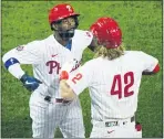  ?? MATT SLOCUM — THE ASSOCIATED PRESS ?? Phillies’ Andrew McCutchen, left, and Bryce Harper celebrate after McCutchen’s two-run home run off Atlanta Braves pitcher Robbie Erlin during the third inning on Friday.