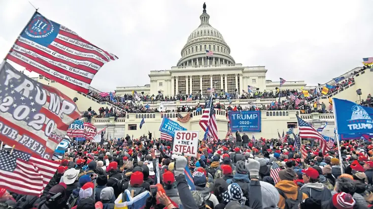  ??  ?? CHAOTIC SCENES: A violent mob of Trump supporters stormed the Capitol, forcing the building into lockdown. Mr Trump called them ‘very special’ and said he loved them.