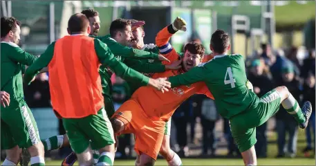  ??  ?? Kyle Suffin goalkeeper of Boyle Celtic celebrates with his team- mates after saving the winning penalty during the FAI Junior Cup Quarter Final match between Carrick United FC and Boyle Celtic at Tom Drohan Park. Pics: Matt Browne/ Sportsfile