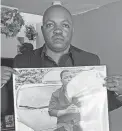  ?? PHOTO/ANNA NICHOLS
AP ?? Peter Lyoya holds up a picture of his son Patrick Lyoya, 26, in his home in Lansing, Mich., last week.