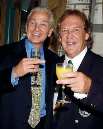  ?? GETTY IMAGES ?? David English, right, with former England captain David Gower at the launch of English’s memoir, Mad Dogs and the Englishman, in 2003.