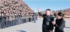  ?? Korea. | AFP ?? NORTH Korea’s leader Kim Jong Un and his daughter greeting scientists and engineers from a defence science research institute, and workers at a munitions factory, who contribute­d to the test-firing of the new interconti­nental ballistic missile, at an unknown location in North