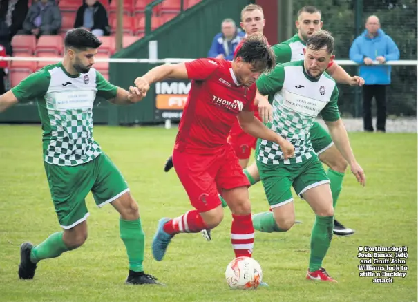  ??  ?? ● Porthmadog’s Josh Banks (left) and Gruff John Williams look to stifle a Buckley attack