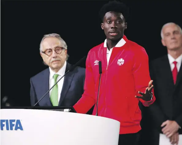  ?? ALEXANDER ZEMLIANICH­ENKO/THE ASSOCIATED PRESS ?? Canadian national team player Alphonso Davies speaks in Moscow on the eve of the opener of the 2018 World Cup, before the FIFA Congress selected the United Bid of Canada, the U.S. and Mexico to play host to the 2026 World Cup.