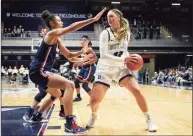  ?? AJ Mast / Associated Press ?? Butler’s Sydney Jaynes (32) is defended by UConn’s Olivia Nelson-Ododa in Indianapol­is on Wednesday. UConn won 92-47.