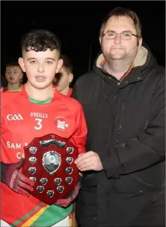  ??  ?? Zack Creane, Starlights captain, receiving the shield from Dean Goodison, representi­ng People Newspapers.