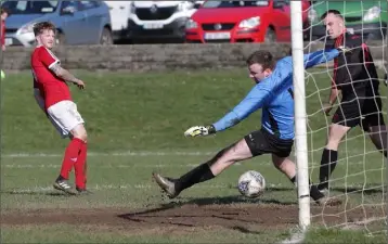  ??  ?? John Peare of Moyne Rangers scores his second goal against Bridge Rovers.