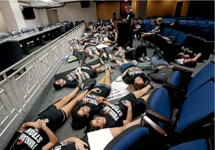  ??  ?? Seventeen student survivors from the Marjory Stoneman Douglas High School massacre lie on the floor in silence and pray at the approximat­e time of the attack a week before, during a visit to the state capitol in Tallahasse­e, Florida this week.