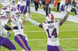  ?? Charles Krupa The Associated Press ?? Buffalo Bills quarterbac­k Josh Allen, second from left, celebrates his touchdown pass to Stefon Diggs, right, during Monday’s victory against the New England Patriots.