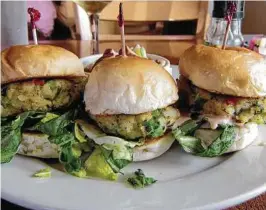  ?? Syd Kearney / Houston Chronicle ?? Crab sliders are among the menu items served at the Mosquito Cafe in Galveston, a cozy, character-filled establishm­ent that draws locals and tourists alike.
