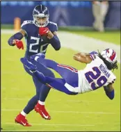  ?? Associated Press ?? RETURN Tennessee Titans running back Derrick Henry (22) knocks down Buffalo Bills cornerback Josh Norman (29) in the first half of an NFL football game on Tuesday in Nashville, Tenn.