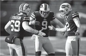  ?? BRETT CARLSEN/AP ?? Bills long snapper Reid Ferguson (69), punter Corey Bojorquez (9) and kicker Tyler Bass celebrate an extra point against the Colts during an AFC wild-card playoff game on Jan. 9 in Orchard Park, N.Y.