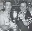 ??  ?? John Barrow, left, and Ralph Sazio hold the Grey Cup after theHamilto­n Tiger-Cats, with one ofthemost dominant teams in CFL history, trounced Saskatchew­an, 24-1, inOttawa, 50 years ago today.