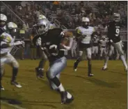  ??  ?? Cedartown’s Quan Neal looks for running room around the Rockmart defense.