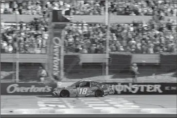  ?? The Associated Press ?? OUT IN FRONT: Kyle Busch crosses the finish line to win the NASCAR Cup Series auto race at Pocono Raceway Sunday in Long Pond, Pa.