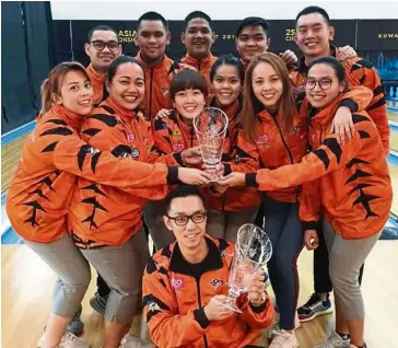  ??  ?? Ecstatic: The Malaysian bowlers celebratin­g after becoming overall champions in the Asian Tenpin Bowling Championsh­ips after Esther Cheah nicked the women’s Masters gold in Kuwait yesterday.