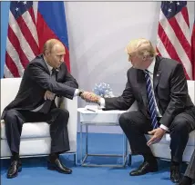  ?? STEPHEN CROWLEY / THE NEW YORK TIMES ?? President Donald Trump and Russian President Vladimir Putin shake hands last month at the G-20 summit in Hamburg, Germany. Before the U.S. sanctions vote, the Kremlin had expected the face-toface meeting of the two leaders to set the stage for better...