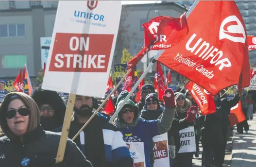  ?? PHOTOS: BRANDON HARDER ?? Striking Unifor members and supporters walk along Broad Street past a number of Crown corporatio­n buildings during Friday morning’s ‘Rally of Fairness.’