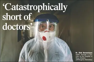  ?? (AP/Evgeniy Maloletka) ?? Dr. Oleh Hornostaye­v walks through a corridor at the hospital in Stryi, Ukraine.