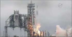  ??  ?? In this image from NASA TV, the SpaceX Falcon rocket launches from the Kennedy Space Center in Florida on Sunday. It’s carrying a load of supplies for the Internatio­nal Space Station.