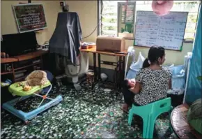  ?? PHYO HEIN KYAW/AFP ?? Aye Mar (not her real name), eight months pregnant and unmarried, take care of a baby of another single mother taking refuge at the Myint Mo Myittar Single Mothers’ Foundation in Yangon last month.