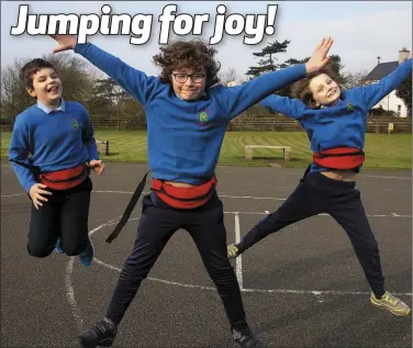  ??  ?? Kevin Murphy, Mathew O’Brien and Fionn McDonald jumping for joy at Ramsgrange NS on Monday.