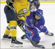  ?? JULIA MALAKIE / LOWELL SUN ?? Umass Lowell’s Connor Sodergren, right, battles Merrimack’s Mac Welsher for the puck during a faceoff Saturday.