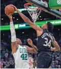  ?? CHARLES KRUPA/ASSOCIATED PRESS ?? Milwaukee Bucks forward Giannis Antetokoun­mpo, right, blocks a shot by Boston Celtics center Al Horford during Game 5 of an Eastern Conference semifinal Wednesday in Boston. The Bucks won 110-107.