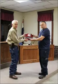  ?? MEGAN DAVIS/MCDONALD COUNTY PRESS ?? The city of Anderson presented former, longtime fire chief, Shelby Turner, with a plaque of recognitio­n at the regular council meeting on Dec. 18. David Abbott is Anderson’s new fire chief.