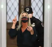  ?? CHIP SOMODEVILL­A Getty Images ?? Rep. Marjorie Taylor Greene, R-Ga., yells at journalist­s on Jan. 12 after setting off the metal detector outside the doors to the House of Representa­tives in Washington, D.C.