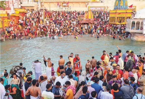  ?? PTI ?? Devotees gather to offer prayers during the third ‘Shahi Snan’ of the Kumbh Mela 2021, amid a raging coronaviru­s pandemic at Har ki Pauri Ghat in Haridwar. Nearly 2,000 devotees including 30 Hindu monks have tested positive for the virus in recent days.