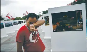  ?? AP/LEFTERIS PITARAKIS ?? Savas Altay weeps Friday in Istanbul at an exhibit of photograph­s from the military coup attempt last year. Altay said he was beaten by a soldier during the turmoil.