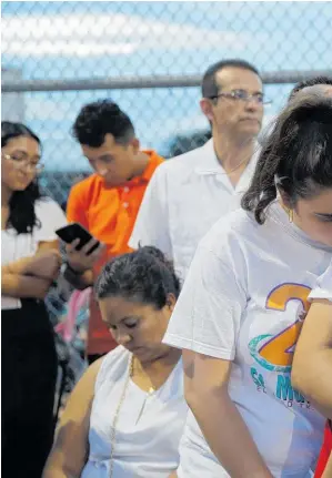  ??  ?? Gabriela Lopez and her husband Roberto Lopez comfort their children Santi Lopez and Max Lopez during a vigil for victims of the mass shooting at a shopping complex in El Paso.