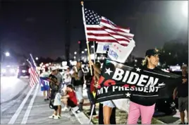  ?? PTI ?? Jupiter resident Kathy Luksch, right, stands with others gathered to support former President Donald Trump on South Ocean Boulevard near Mar-a-Lago in Palm Beach, Florida. "How dare they!" Luksch said, referring to the FBI's raid on Mar-a-Lago