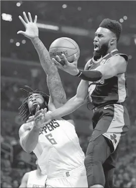 ?? Mark J. Terrill Associated Press ?? DeANDRE JORDAN RETURNED to the Clippers’ lineup Wednesday night and tried to stop Boston guard Jaylen Brown during the first half.