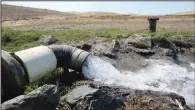  ?? (AP/Rich Pedroncell­i) ?? Well water flows from pumps July 25 into a canal that will be used to irrigate a vineyard run by Hamilton.