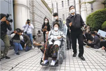  ?? AHN YOUNG-JOON AP ?? Former South Korean comfort woman Lee Yong-soo (in wheelchair) leaves the Seoul Central District Court in Seoul, South Korea, on Wednesday after a judge rejected a sexual slavery claim against Japan.