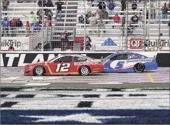  ?? Curtis Compton / Associated Press ?? Ryan Blaney (12) passes Kyle Larson with eight laps remaining on his way to winning a NASCAR Cup Series auto race at Atlanta Motor Speedway on Sunday in Hampton, Ga.