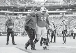  ?? DAVID SANTIAGO dsantiago@miamiheral­d.com ?? Hurricanes center Jakai Clark walks off the field after being injured during the second quarter against the Tar Heels on Saturday at Hard Rock Stadium.