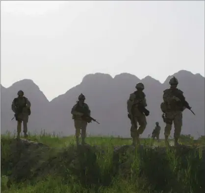  ?? COLIN PERKEL, THE CANADIAN PRESS ?? Canadian soldiers patrol in southern Afghanista­n in 2009. NATO and the U.S. want more support, and that is starting to look like a return to Canadian boots on the ground, writes Thomas Walkom.