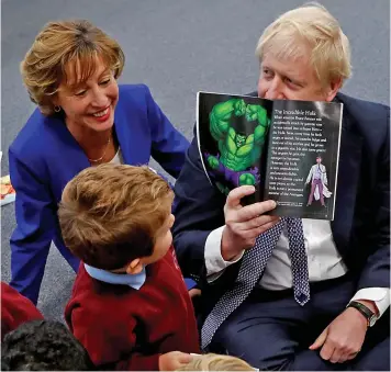  ?? Pictures: REUTERS ?? My hero...Boris Johnson chats about an Incredible Hulk story at a Taunton school yesterday