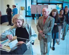  ?? GETTY IMAGES ?? A French citizen casts her ballot Saturday at the Embassy of France in Washington, D.C., in early voting for the country’s presidenti­al election.