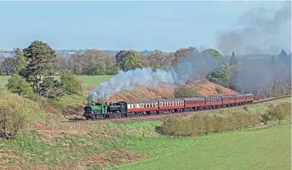  ?? ROBERT FALCONER ?? The popular pairing of Nos. 813 and 7714 climb Eardington Bank on April 17 with a seven-coach load from Kiddermins­ter to Bridgnorth.