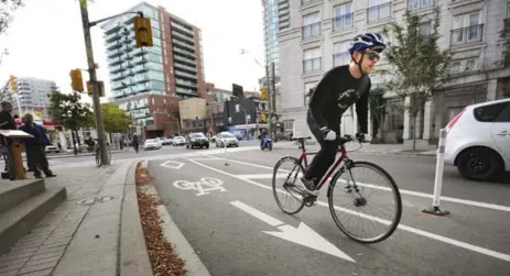  ?? RICHARD LAUTENS/TORONTO STAR FILE PHOTO ?? A cyclist uses the new bike lane on Richmond St. E. near Jarvis St. that came into being last September. Cycling numbers continue to rise in Toronto.